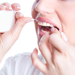 Dr. Lehrman helps prevent periodontal disease by flossing in New York